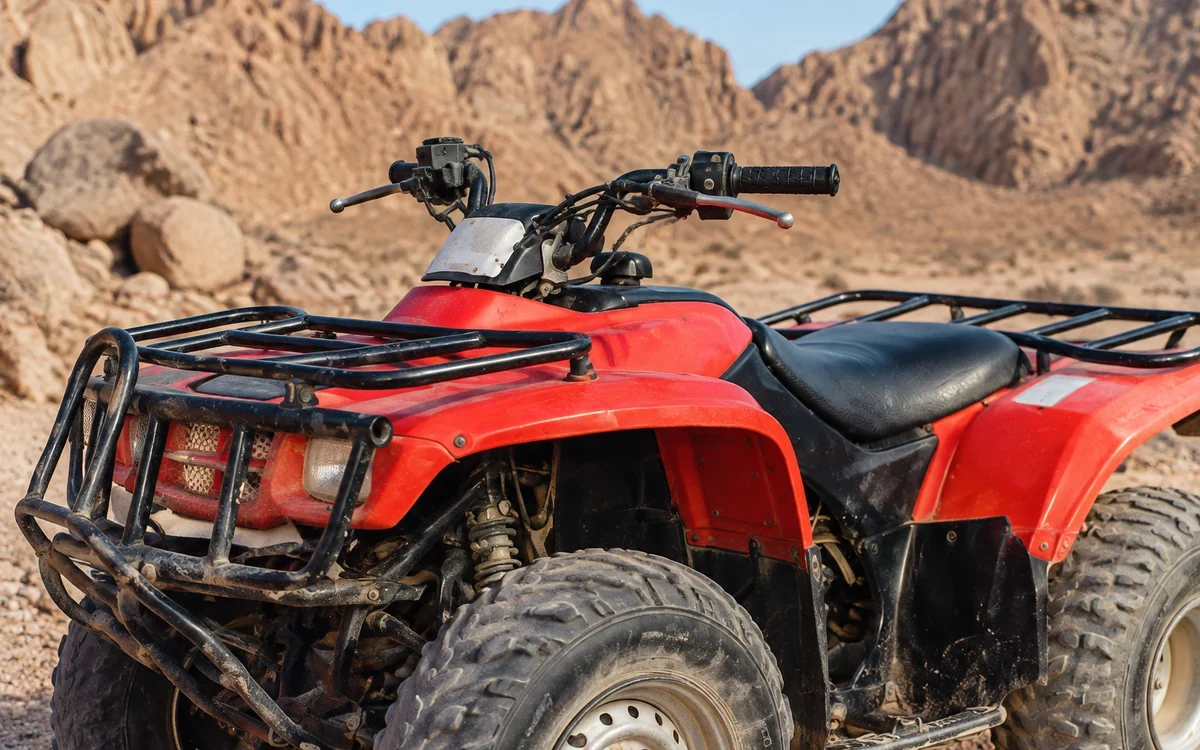 Illustration of a parked red quad in rocky desert