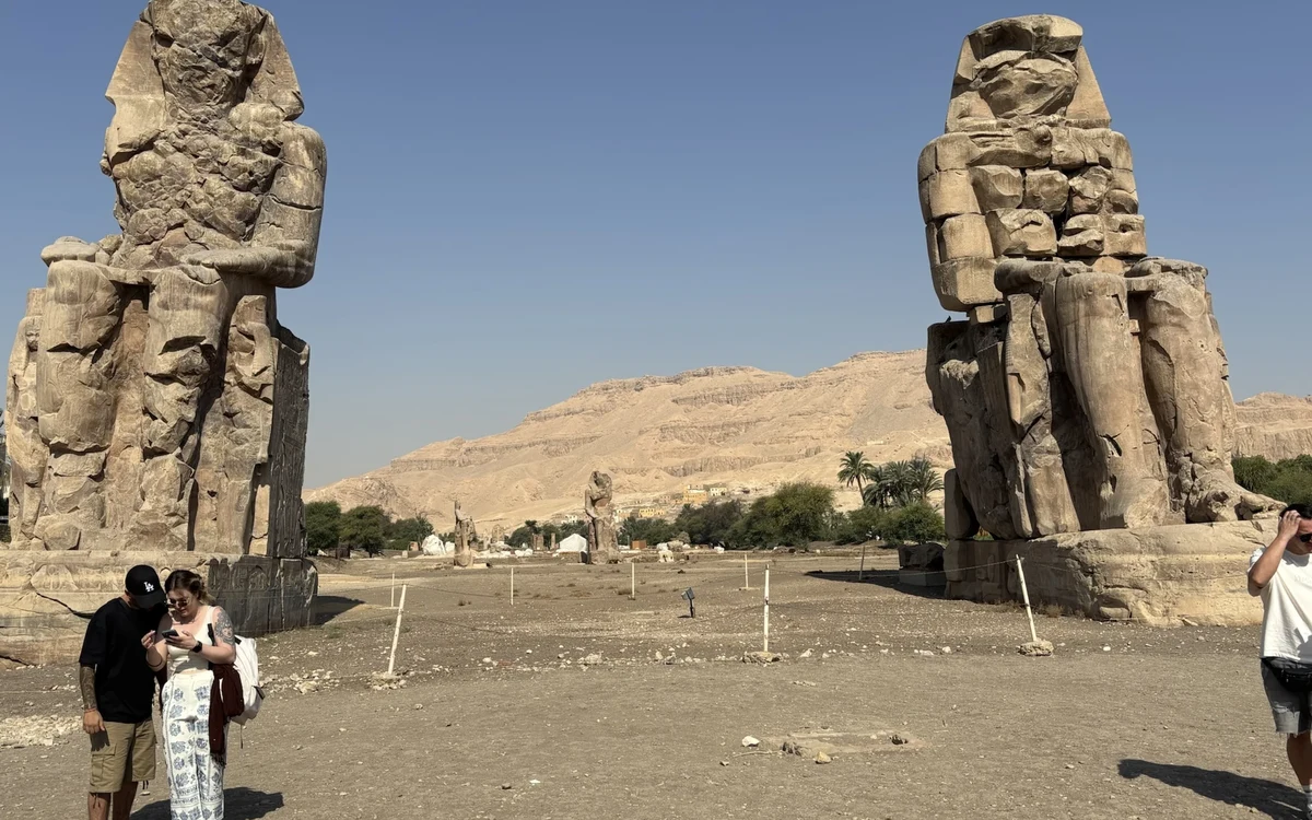 Colossi of Memnon beside rocky hills
