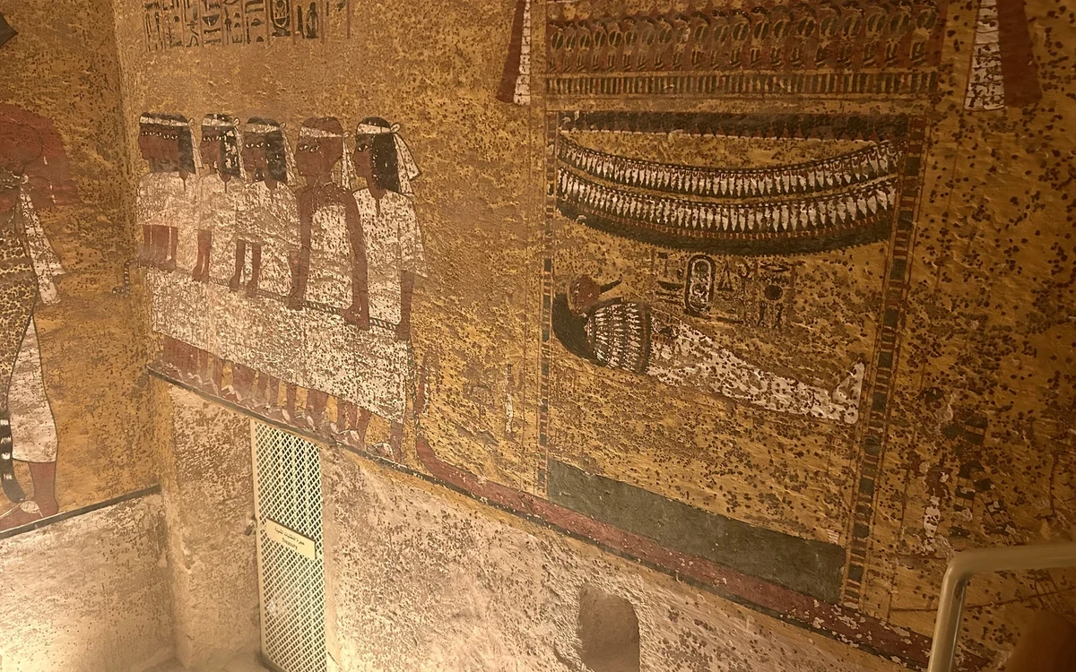 Painted figures and hieroglyphs on an ancient tomb wall
