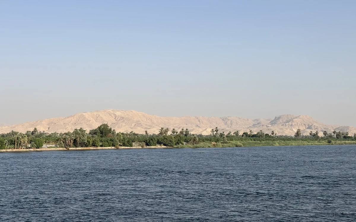 Nile water with palms and distant hills