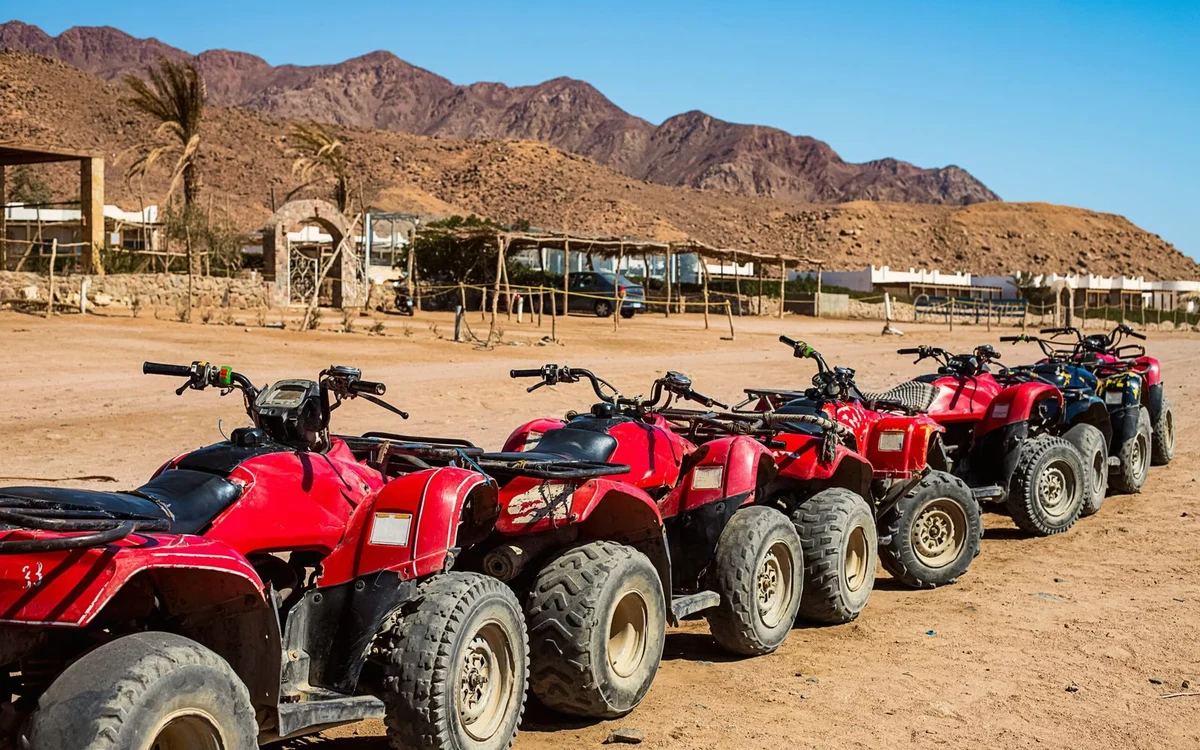 Parked red quad bikes in the desert