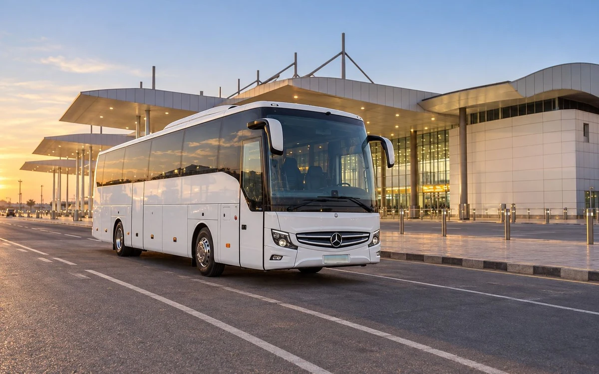 White coach outside an airport terminal