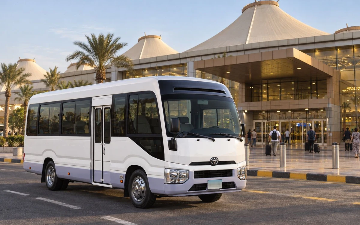 White minibus outside an airport terminal