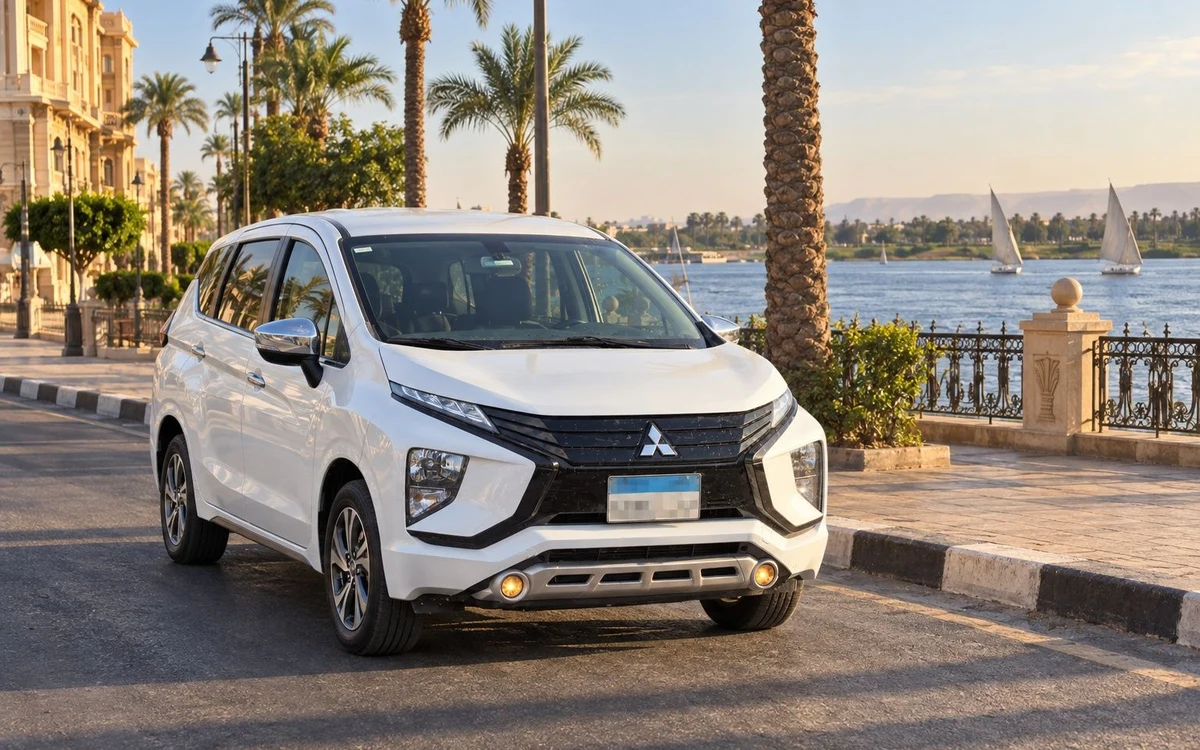 White vehicle beside a riverside promenade