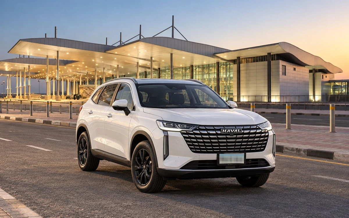 White SUV outside an airport at sunset