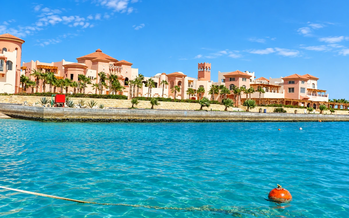 Resort buildings along a turquoise waterfront